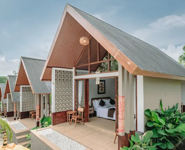 A-frame cottages with timber gables and terraces at Air Ilir Grand Villa