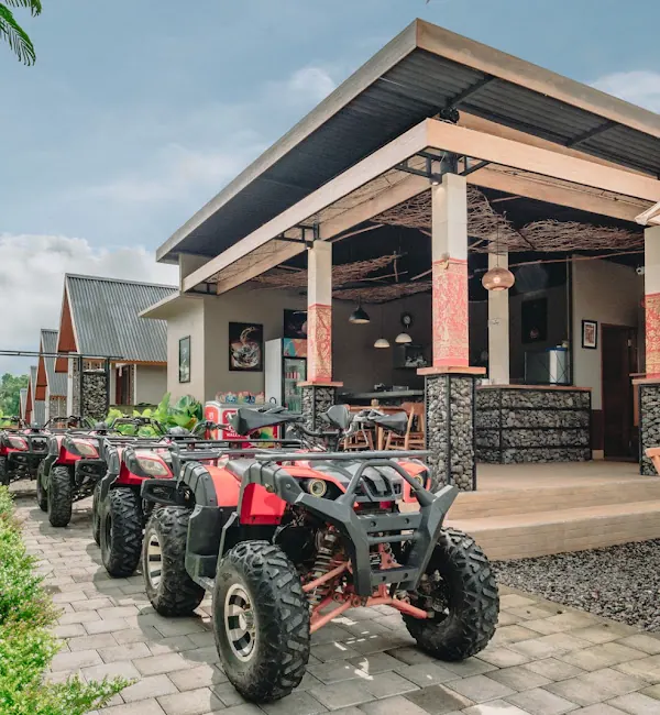 ATV quad bikes lined up in front of the villa's open-sided pavilion