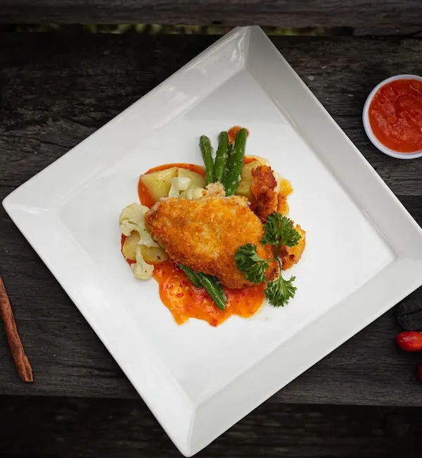 Crumbed chicken with vegetables and sambal, plated at the villa