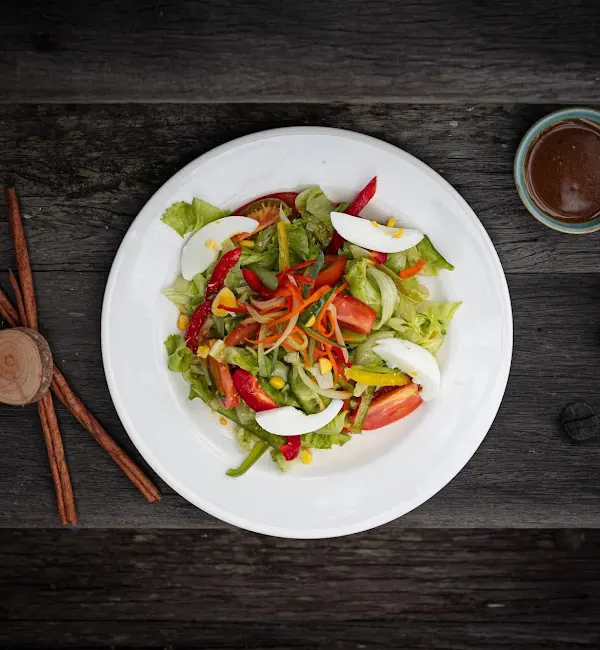 A fresh salad with egg, tomato and peppers, plated at the villa